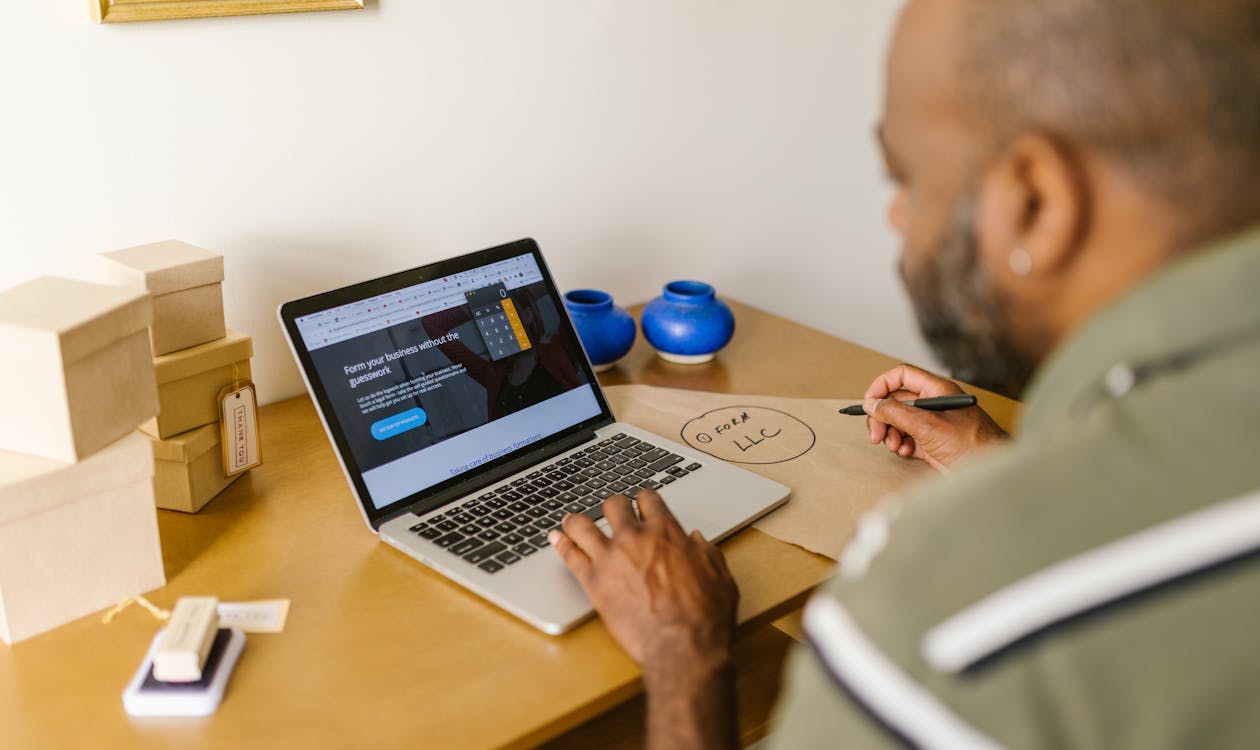 A small business owner using AI on their laptop, representing the gap between AI-using and non-AI-using businesses